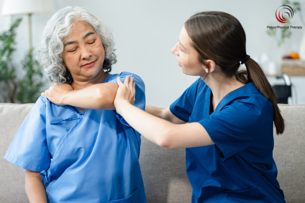 A physical therapist in Manhattan helping a patient with her frozen shoulder.