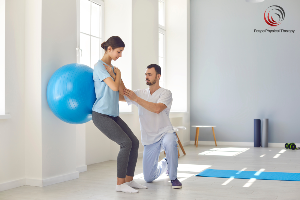 A physical therapist helping a patient perform strengthening exercises to treat lumbar radiculopathy in New York.