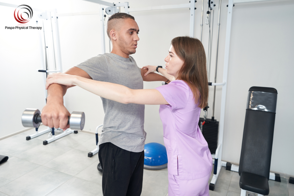 A physical therapist helping a patient strengthen their biceps to treat Tendonitis in Manhattan, New York.