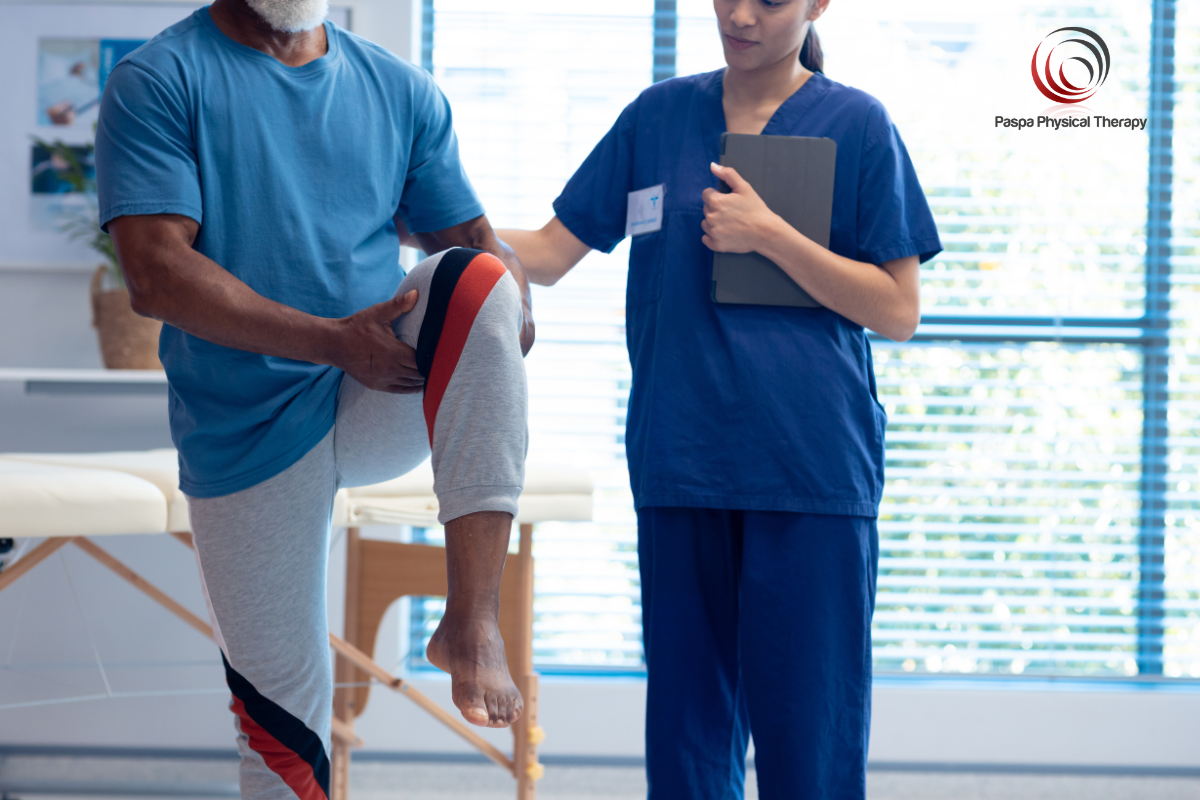A physical therapist treating a patient with knee pain in New York.
