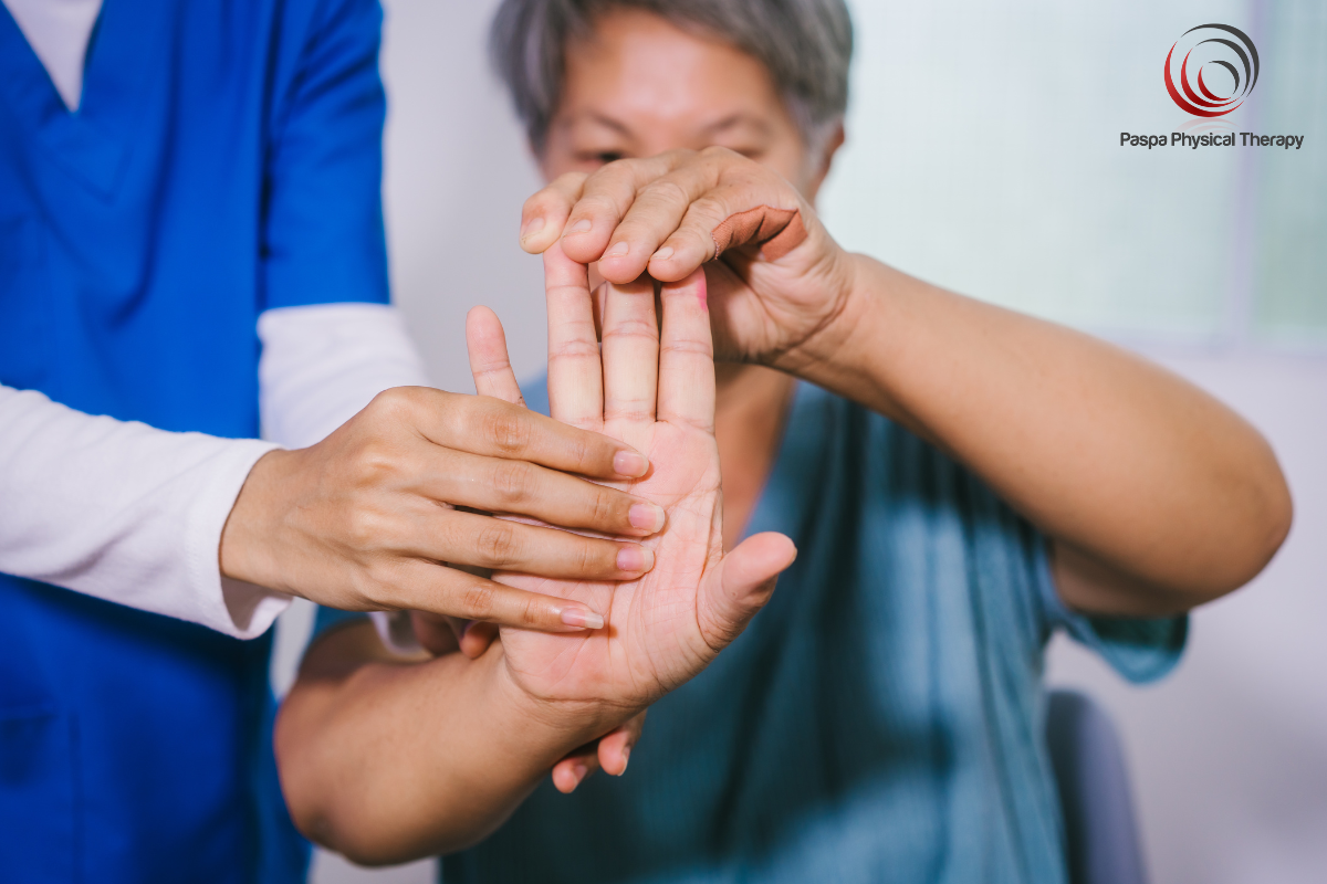 A physical therapist showing a patient hand exercises to perform to treat her hand arthritis in Manhattan, New York.