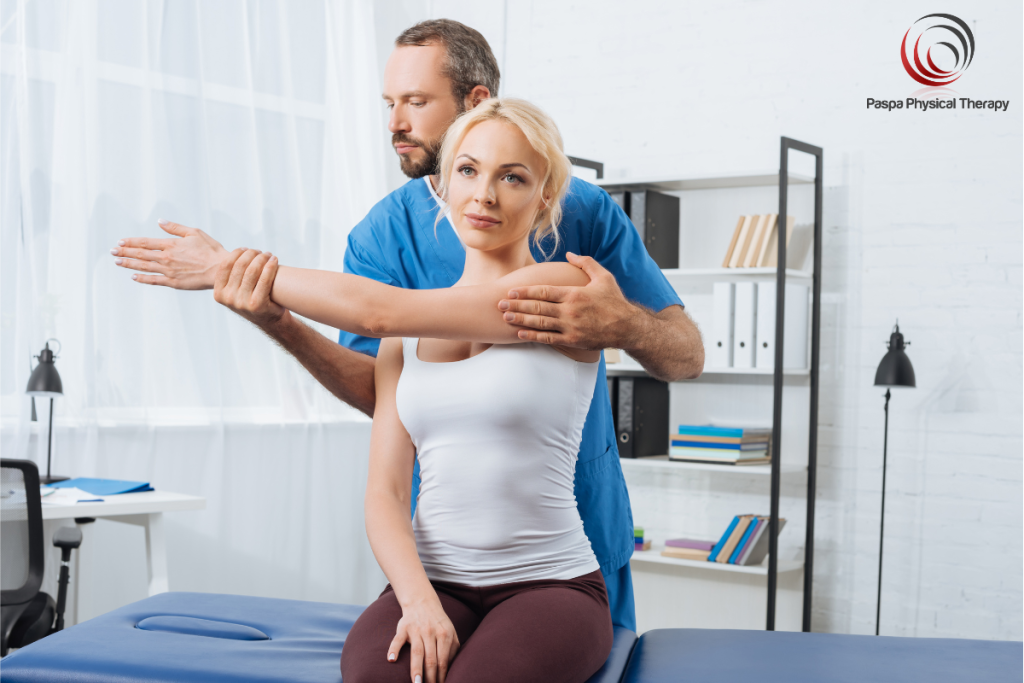 A physical therapist helping a patient stretch her shoulder to help her restore her range of motion that has been affected by Impingement in Manhattan, New York.
