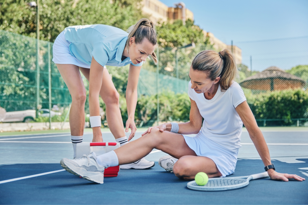 A tennis medic helping woman with knee injury in Manhattan, NY.